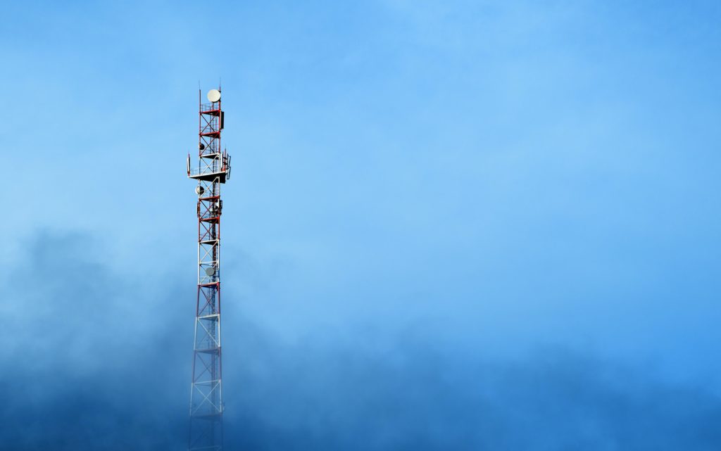 Cell tower on blue sky background